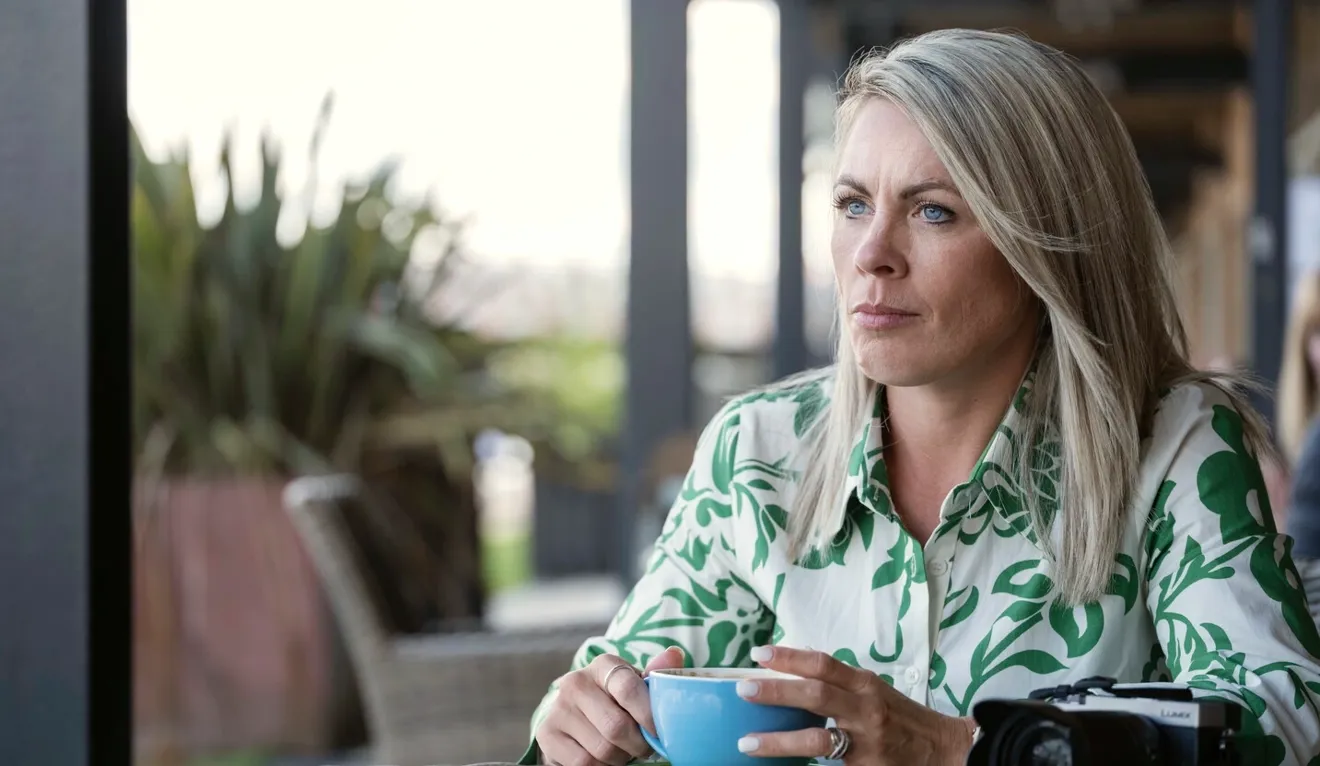 Bilde av Laura som sitter i stuen sin. Multippel sklerose forårsaker skader i nervesystemet, noe som forstyrrer signalene fra hjernen, og kan påvirke både blære- og tarmfunksjonen. 