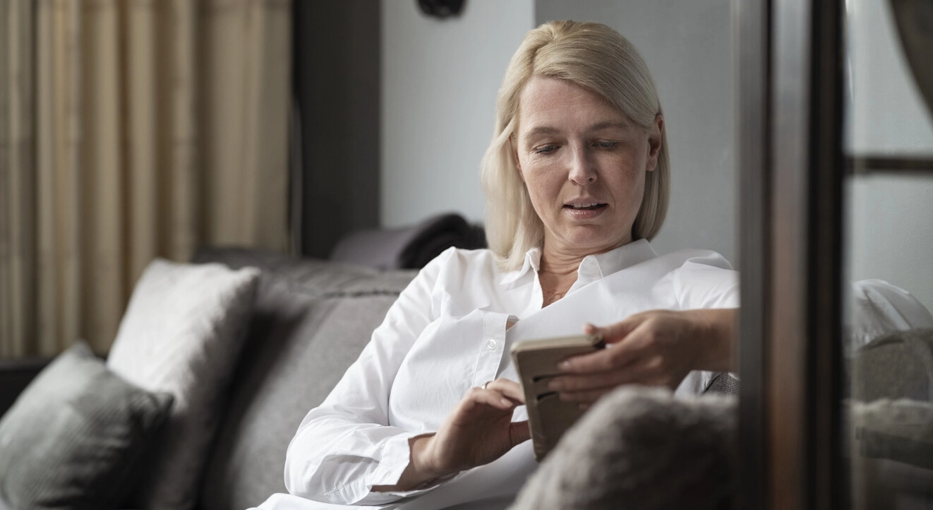 Bilde av Ilse sittende i stuen sin. Multippel sklerose forårsaker skade på nervesystemet, forstyrrer signalene fra hjernen og kan derfor påvirke en rekke kroppsfunksjoner. Blæren kan være spesielt utsatt for forstyrrelser.  